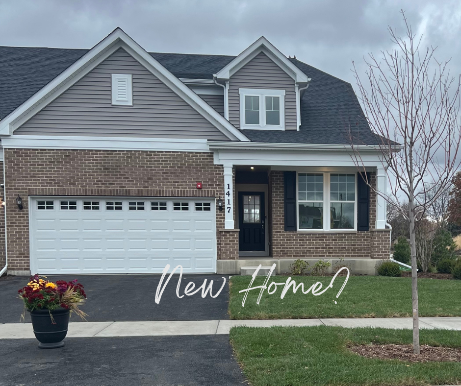 home with a beige and brick front, a 2 car garage, and a small front porch. 